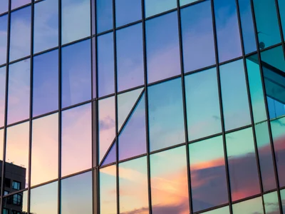Facade panels catching different sky colors at angles