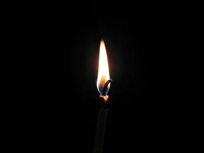 Single match flame in darkness