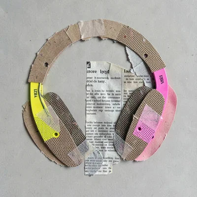 Collage of layered headphone shapes cut from kraft paper with dotted halftone ov