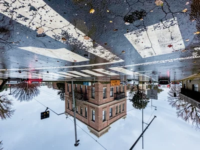 Crosswalk reflected in wet intersection