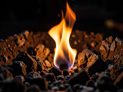 Single ember holding heat in ash