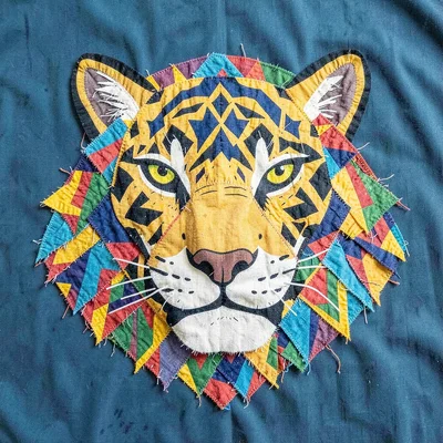 Panamanian mola textile illustration, a jaguar face with geometric patterned fur