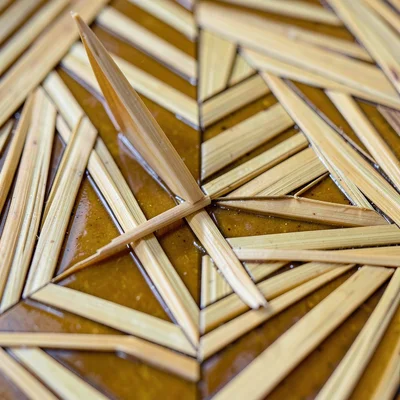 Close-up of a straw field with a single straw lifted at a corner, showing the la