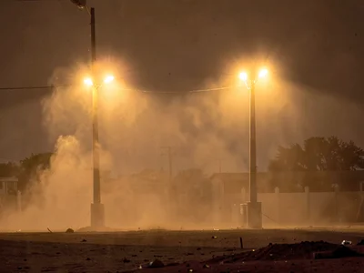 Electric lights glowing with exaggerated coronas through dust