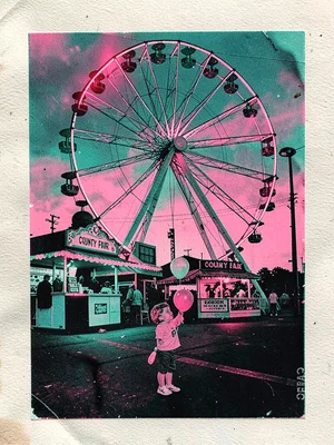 County fair Ferris wheel half lit at dusk with a corn dog stand and a child hold