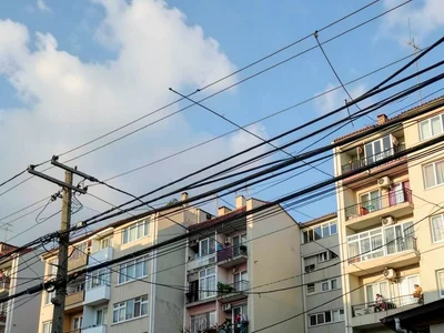 Power lines layered against apartment buildings