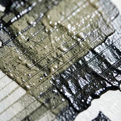 Mineral-texture macro of an inked plate showing roller-track texture, oil-rich i