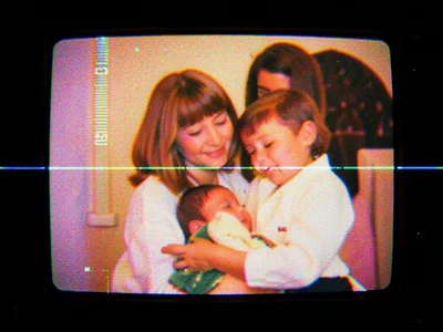 VHS recording of mother with baby, warm tones, slightly degraded, 1990s home vid