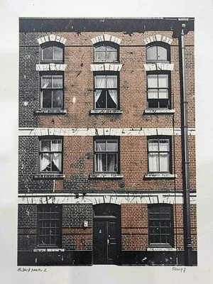 Old industrial building facade — brick courses and window blocks in bold two-col