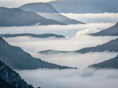 Five ridge layers each lighter into mist