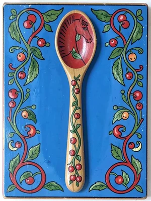 Folk-painted wooden spoon — kurbits leaf and berry pattern along handle