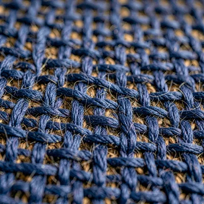 Tight grid of plain-weave indigo-dyed wool warp threads showing crisp tension an