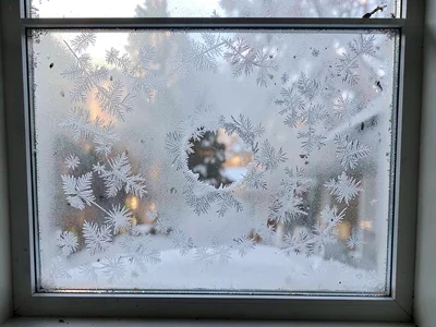 Breathing hole in morning window frost