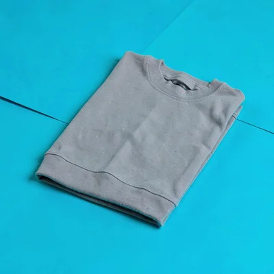 single matte-grey knee-support sleeve folded flat at three-quarter on a saturate