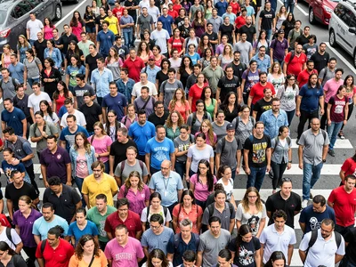 Crosswalk crowd compressed into layers of people