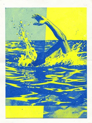 A swimmer mid-dive in blue and fluorescent yellow, the water surface cutting the