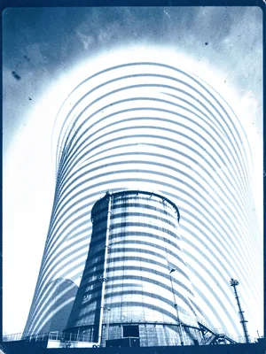An industrial cooling tower, sun arc bands rising above the curved form
