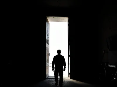 Figure against bright doorway