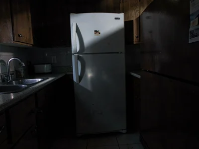Refrigerator light in dark kitchen