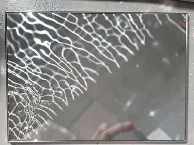 Silver mirror showing rippled image