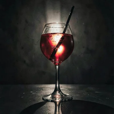 Vertical of a glass shot from below with backlit ruby spritz