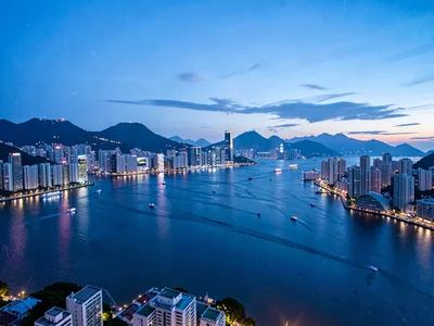 Hong Kong harbor at blue hour, entire sweep from Kowloon to Central to Peak