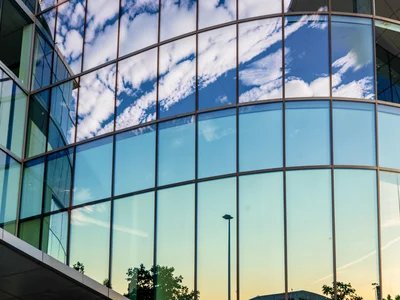 Curved glass showing distorted sky gradient