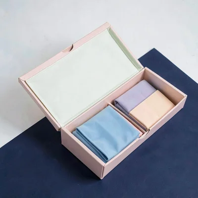 Catalog shot of a pastel set open on a deep navy color-block, crisp wraparound l