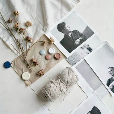 A scattered moodboard of fabric, paint chips, dried flowers, abstract photo prin