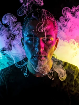 Portrait through smoke using colored gels on opposing lights, control of chaos