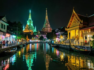 Canal neon reflection with distant temple spire