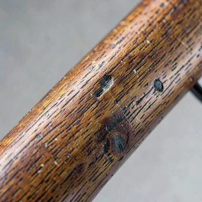 worn wooden rifle stock detail, grain study, neutral palette