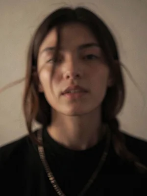 Portrait subject who moved slightly during five minute exposure, face becoming s