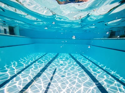 Sunlight filtered through a swimming pool surface viewed from below, the caustic