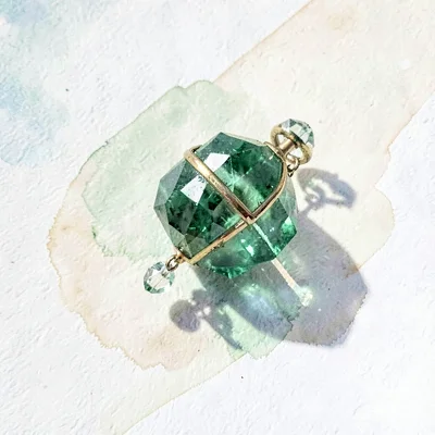 Petite peridot lowpoly tambourine with a small faceted ring and crystalline jing