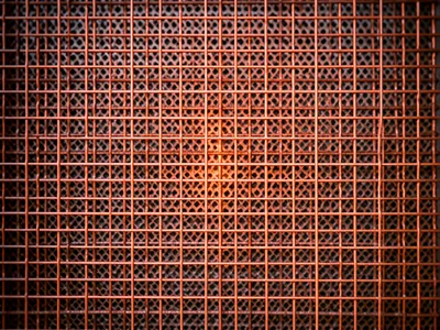 Copper wire mesh tarnishing, bright new copper at center fading to dark oxidized