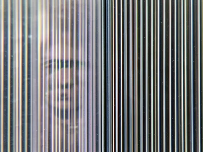 Macro of lenticular lens surface, parallel cylindrical ridges creating striped t
