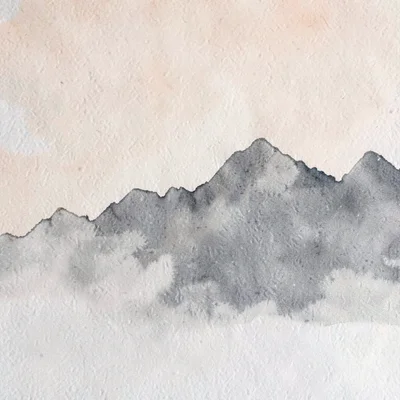 A serrated mountain ridge silhouette runs across the upper-fifth in pale charcoa
