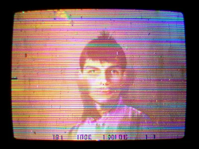 Frozen frame with heavy tracking noise, image barely recognizable beneath rollin