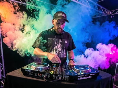DJ at booth with color wash