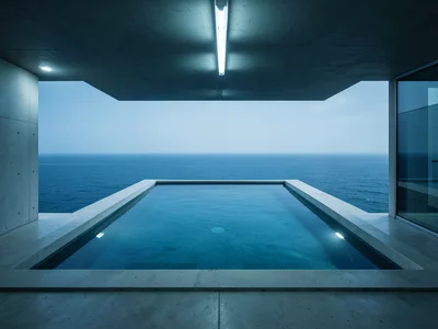 Infinity pool on a rooftop merging with the ocean horizon, minimalist concrete s