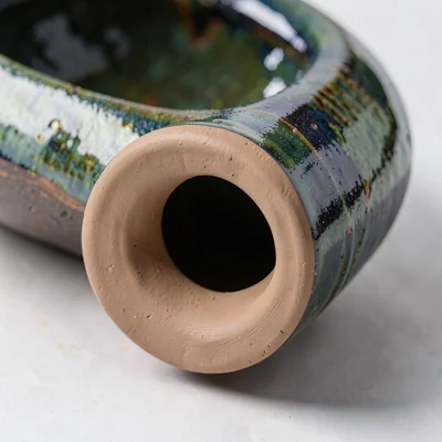 Close-up of the foot of a thrown bowl trimmed clean, showing the turned clay rin