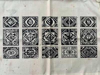 Multiple stamps in row — single symbol repeated across cloth, slight variation e