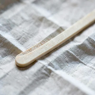 Mineral close-up of a bone folder resting on a creased fold