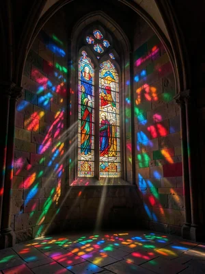 A Gothic church interior, light streaming through a tall lancet window, colored 