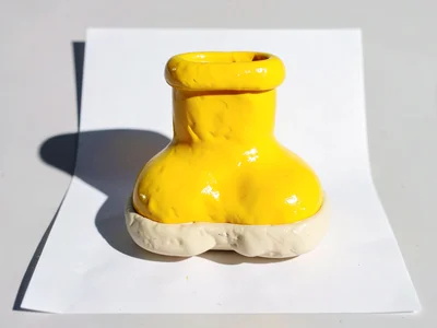 Cuddly chunky clay rubber boot in primary yellow with stubby cream-toned sole an