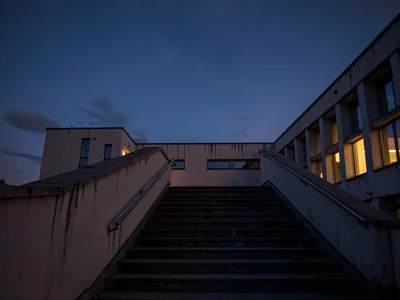 Observatory stairs ascending toward darkening sky