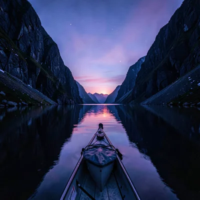 Polar liminal light, extended blue hours, A kayak on glassy water between mounta