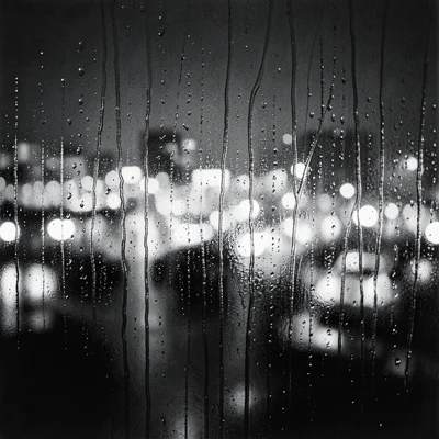 Rain-streaked window with the blurred lights of a city night beyond, individual 