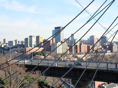 City skyline compressed behind bridge cables